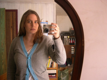 woman looking in mirror at weight gain