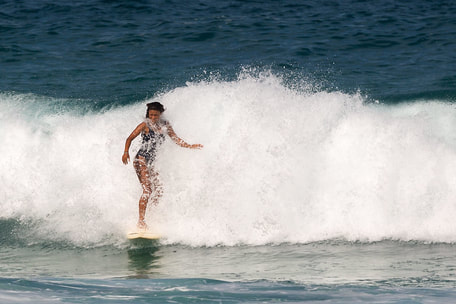 woman surfing in waves